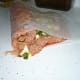 Roll into a log using the wax paper. Do not pick up it will fall apart. Roll right into the greased baking pan.
