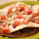 A simple fresh salsa accompanying a bean and vegetable quesadilla.