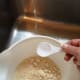 Add the water 1 Tablespoon at a time into one side of the bowl.