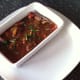 Kangaroo peanut satay is added to a serving dish on a plate