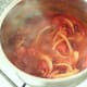 Chilli sauce is brought to a simmer