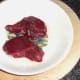 Kangaroo steaks are oiled for griddling