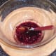 Pomegranate seeds and peach juice stirred in to oil