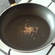 Toasting cumin seeds in dry frying pan