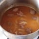 Chicken stock is added to pot
