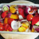 Mediterranean vegetables are seasoned and prepared for roasting