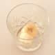 Frozen banana pieces are added to cocktail serving glass