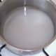 An equal quantity by volume of water is added to the sugar
