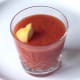 Frozen lemon wedge is added to glass