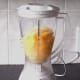 Preparing to blend grapefruit, mango and pineapple