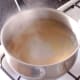 Spaghetti is simmered in boiling salted water