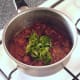 Chopped coriander is added to curry sauce