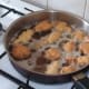 Deep frying battered frogs' legs