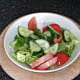 Salad is seasoned with salt, pepper and lemon juice