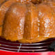 Glaze the hot cake by brushing on or spooning the hot glaze over every inch of the cake.