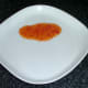 Sweet chilli sauce is spread on plate