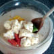 Vegetable pieces are stirred through spiced oil