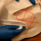 Hold the paper towel or copy paper against the side of the cake and press gently with the fondant smoother to remove imperfections. If you don't have a fondant smoother, you can totally use your hands.
