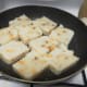 Radish cake slices being pan fried