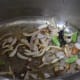 Spices, green chili, and onions being fried