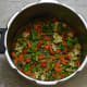 Vegetables being fried inside the cooker base
