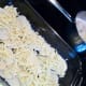 Layer the potato slices and grated cheese