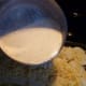Pour the hot cream over the potatoes