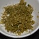 Grind the coriander seeds, ginger, garlic, and green chilies.