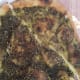 Fatayer za'atar is a pizza-like crust sprinkled with a generous amount of a herb called za'atar.