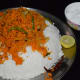 Step five: Pour the mix on the rice. Squeeze lemon juice. Add grated coconut. Mix with your hand. Check for salt. Add if needed.