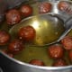 Step seven: Drop these hot balls into very hot sugar syrup. Now, don't cover them.