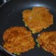 Step four: Let it cook on a medium low fire for a minute. Pour few drops of oil on the edges. Flip it. Add few drops of oil on the top. Cook the other side also till golden brown.