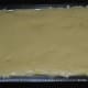 Pour it on the greased tray. Flatten, and extend till the edges. Keep aside for cooling.