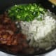 After bacon is browned, move the bacon to the side and add onions and peppers to the bacon grease left in the pan, allowing the onions and peppers to caramelize, or brown slightly.