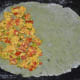 Take a ball and roll it into a 6-inch diameter disc. Spread the stuffing uniformly on half of the disc as pictured.