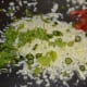 Mix the grated paneer, finely chopped tomatoes, finely chopped coriander leaves, and salt in a bowl. This is the stuffing for the pancakes.
