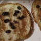 Add raisins on top of frosting.