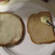 Spread the frosting on the bread.