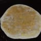 Step eleven: Heat a griddle. Apply some ghee or oil on it. Place the flatbread. Roast both sides, applying some ghee.