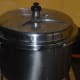 Step eleven: Close the cooker lid. Place the weight. Pressure cook up to 5 whistles and simmer for 15-18 minutes. Turn off the stove.