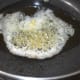 Step two: Heat oil and butter mix. Add cumin seeds. Let them crackle.