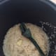 In a rice cooker bowl, combine the daun pandan, sliced ginger, and sliced shallots.