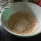 The ingredients in the dough mixed together, with the cream added in, before the cream is mixed in.