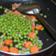 Step four: Throw in green peas and salt.