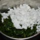 Step four: Transfer the mixture in a mixer or grinder. Add grated coconut.