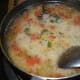 Step six: Slowly slide the roasted semolina into the boiling mix. Give a quick stir to eliminate lumps.