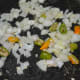 Step three: In the same deep-bottomed pan, add chopped onions and chopped green chilies. Saute until onions become translucent.