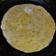 Heat a griddle and add a few drops of oil or ghee. Place the pancake on it and add a few drops of oil or ghee on top.