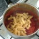 Pasta is added to tomato sauce