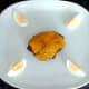Cheeseburger and egg are laid on serving plate